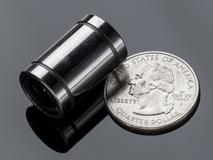 Long Linear Ball Bearing next to quarter