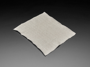 Angled shot of knit jersey conductive fabric square.