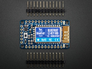 Top view shot of Bluefruit EZ-Key - 12 Input Bluetooth HID Keyboard Controller between 2 12-pin headers.
