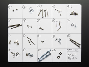 gridded mat with disassembed screws and nuts on it