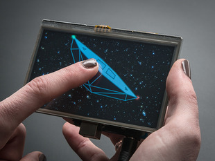 Gray polished white hand holding a Gameduino 2 with 4.3" 480x272 Display and Touchscreen. 