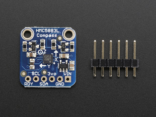 Top down view of a Triple-axis Magnetometer (Compass) Board next to a 6-pin header. 