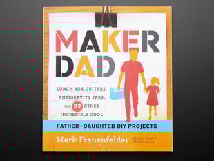 Front cover of "Maker Dad" by Mark Frauenfelder. "Lunch box guitars, antigravity jars, and 22 other incredibly cool father-daughter DIY projects. Cover illustration is of a feature-less father and daughter cartoons.