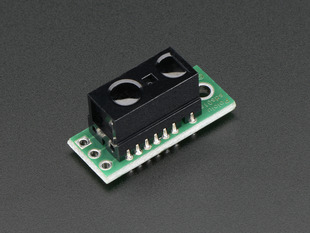 Angled shot of a Sharp GP2Y0D810Z0F Digital Distance Sensor with Pololu Carrier. 