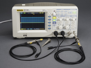 Oscilloscope powered on with probes.