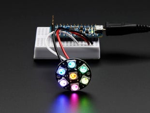 NeoPixel Jewel - 7 x 5050 RGB LED wired to Trinket, lit up rainbow