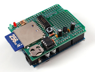 Angled shot of a Adafruit Data logging shield for Arduino with a 256 MB SD card inserted. 