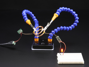 Mini Hand from Hobby Creek with Two Arms holding up some electronics