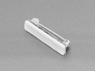 Angled shot of silver pin with foam adhesive.