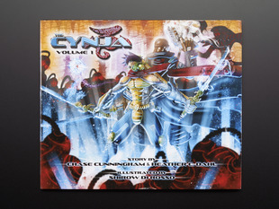 Front cover of "The Cynja: Volume 1" by Chase Cunningham and Heather Dahl and illustrated by Shirow de Rosso. A powerful cyber-warrior wields two swords amid a a chaoic, warlike background.