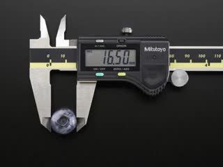 Digital calipers measuring various fruits