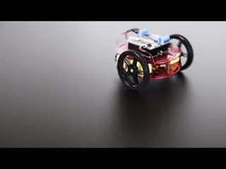 Round two-wheeled robot turning around a few times and then driving off.