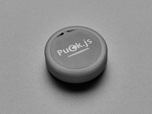 Angled shot of a Espruino Puck.js v2. 