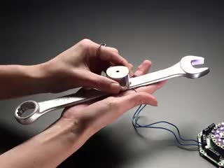 Solenoid holding up a large wrench, then releasing it