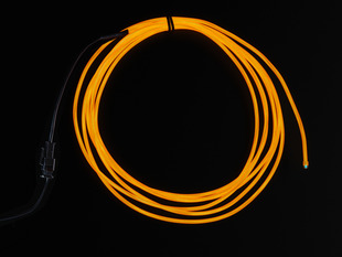 Coil of lit EL wire in orange