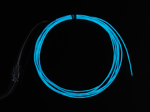 Coil of lit EL wire in blue