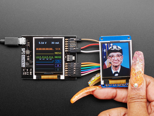 SPIDriver by Excamera Labs attached to a built-in color screen with an image of a white woman on it. 