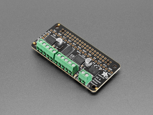 Angled shot of motor breakout board with green terminal blocks.