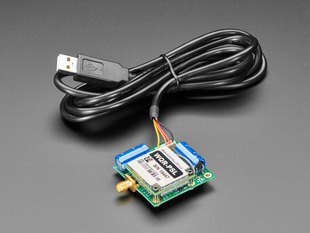 Angled shot of a RockBLOCK 9603 with USB Cable - Iridium Satellite Modem Bundle. 