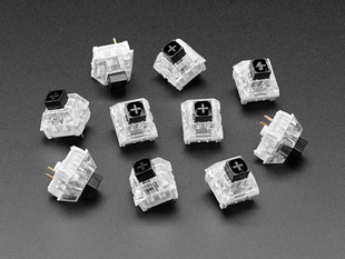 Angled shot of ten black Kailh key switches.