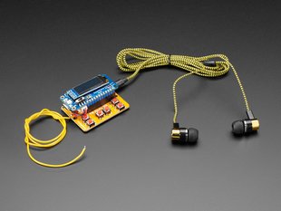 Angled shot of radio kit with black earbuds.
