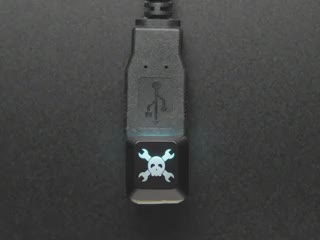Top view video of a Hackaday R4 keycap on a NeoKey glowing rainbow colors.