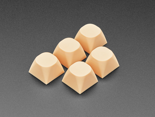 Angled shot of five cream orange MA keycaps. 