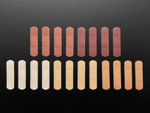 Five sets of bandages in four shades of brown out of their protective paper backing.