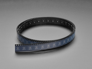 Angled shot of long black plastic reel with 100 microchips.