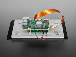 Close-up of FPC ribbon cable connecting a Raspberry Pi to a 7" touchscreen.