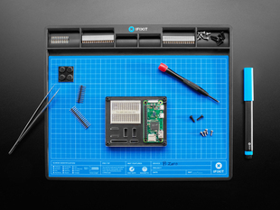 Overhead shot of blue anti-static work mat with various electronics.