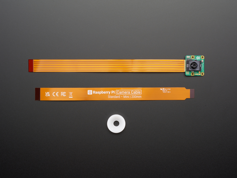Top Down Front Shot of the Raspberry Pi AI Camera with Included Camera Cables and Adjustable Focus Ring