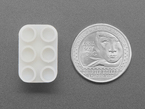 Top Down Bottom Shot of the Lego Slide Switch next to a U.S. Quarter for Scale.