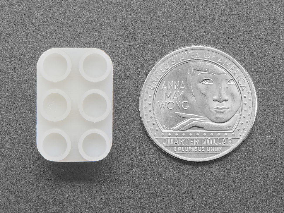 Top Down Bottom Shot of the Lego Slide Switch next to a U.S. Quarter for Scale.