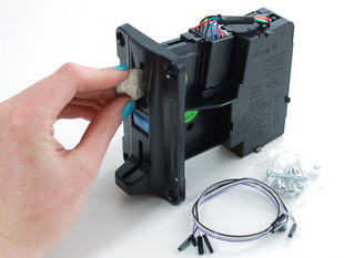 Hand inserting quarter into coin mechanism slot