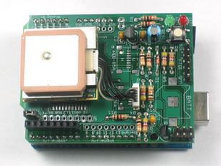 Close up view of a Adafruit GPS logger shield kit connected to an Arduino. 